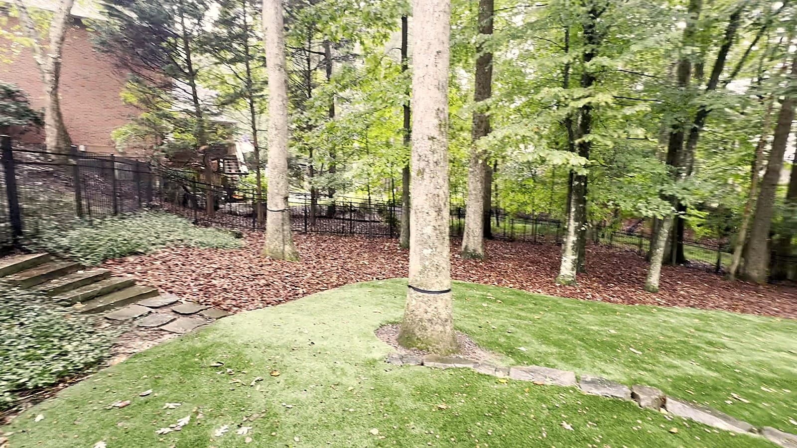 Fresh mulch installed across the beds of a premium wooded north Atlanta backyard
