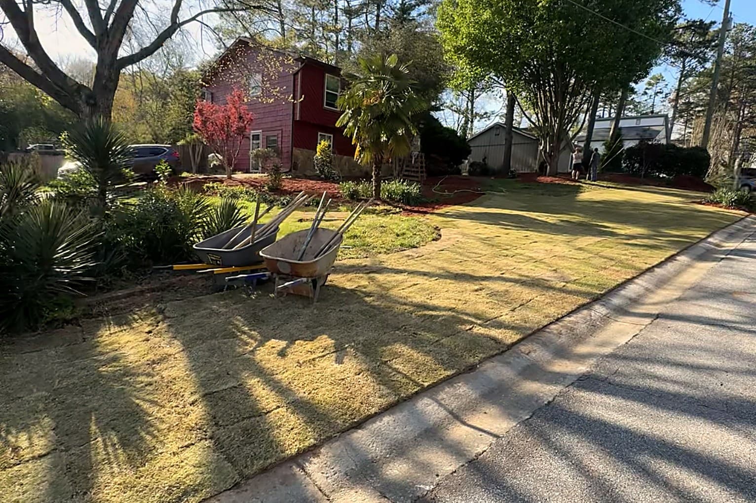 Full, freshly installed green sod lawn across a north Atlanta front yard